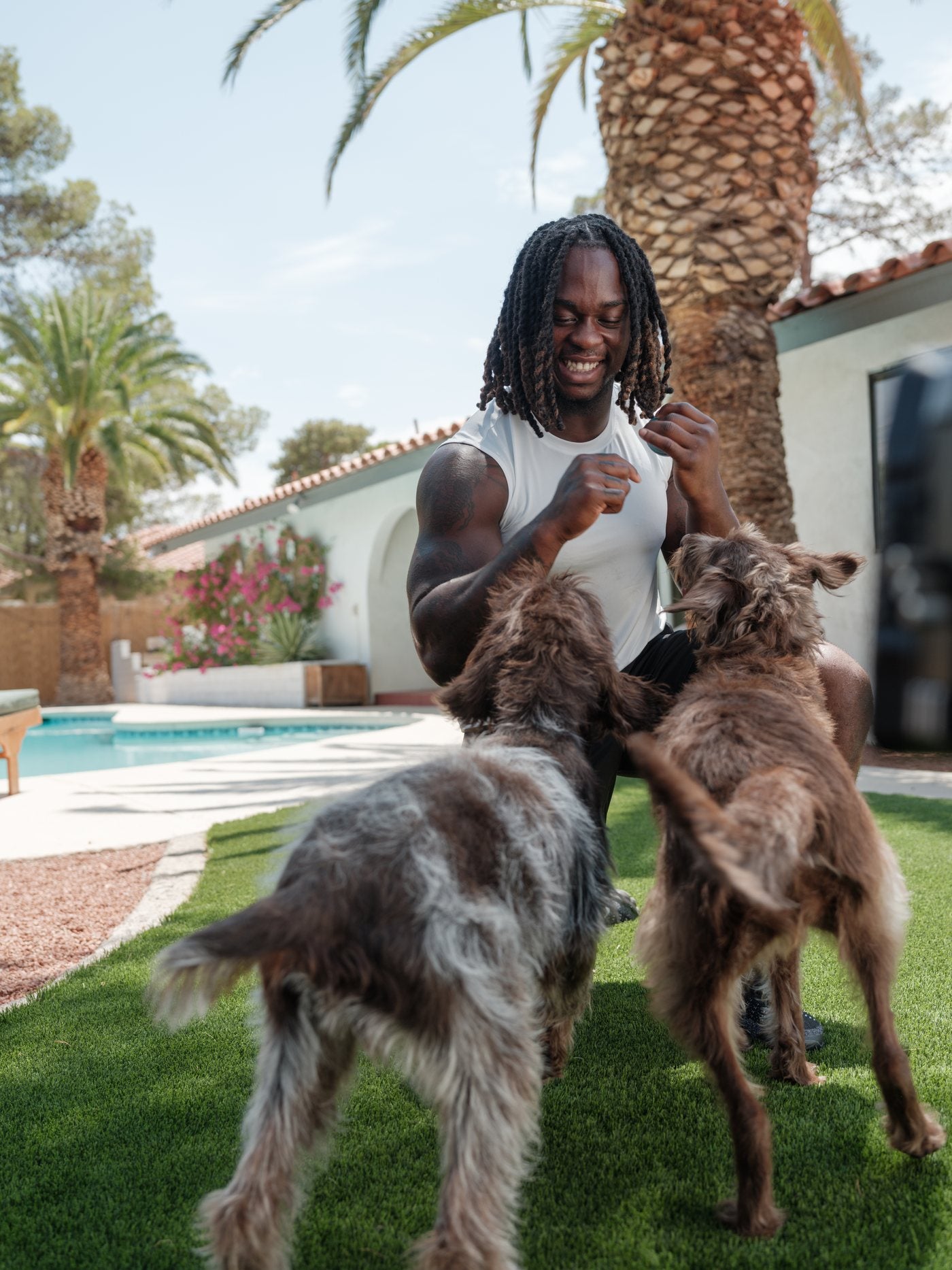 Ashton Jeanty treating his dogs Coco and Deuce