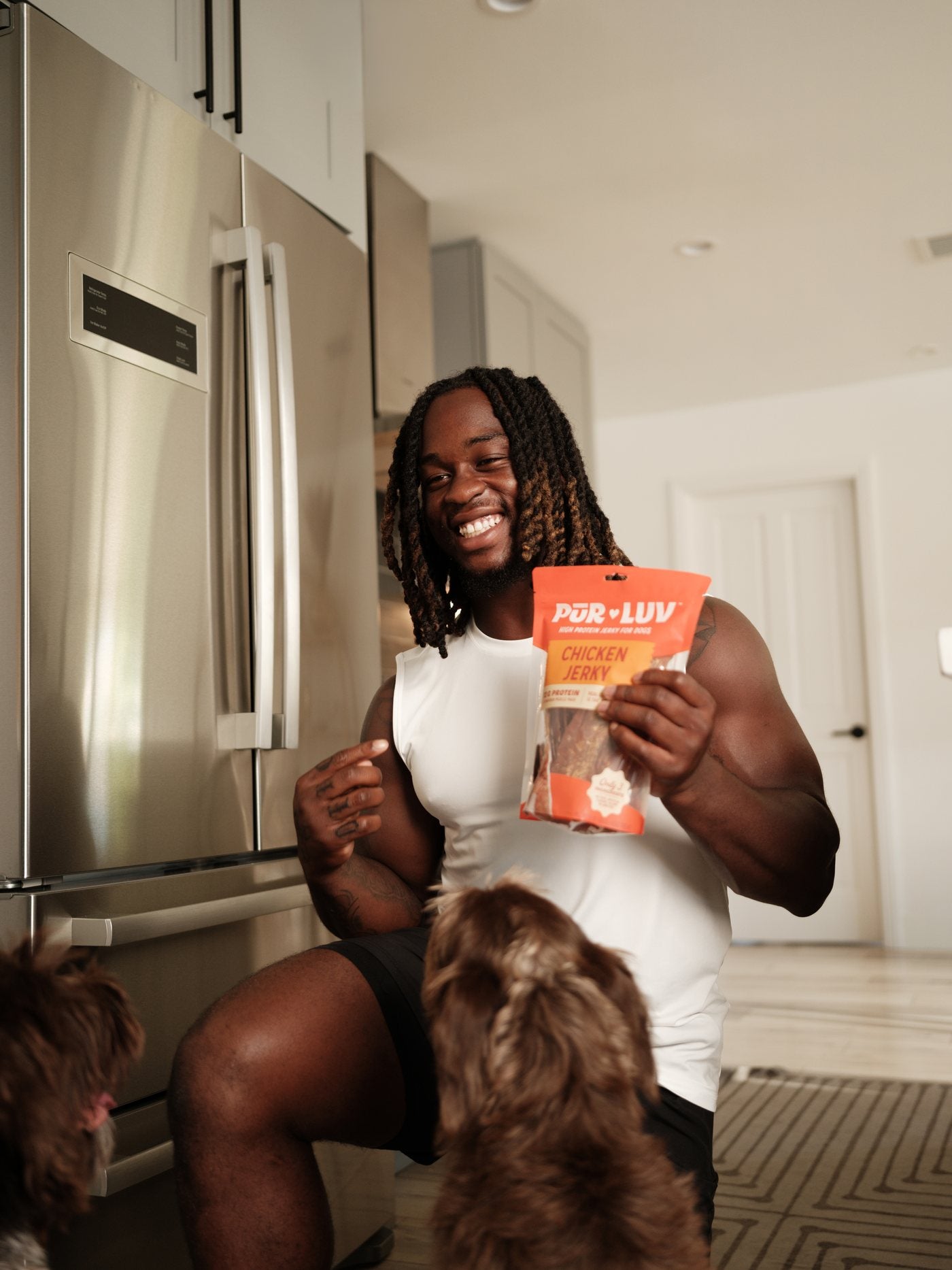 Ashton Jeanty with a bag of Pur Luv chicken jerky